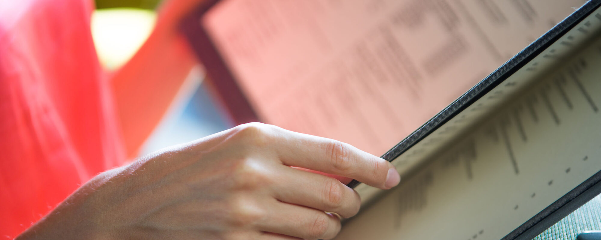 Woman holding restaurant menu.