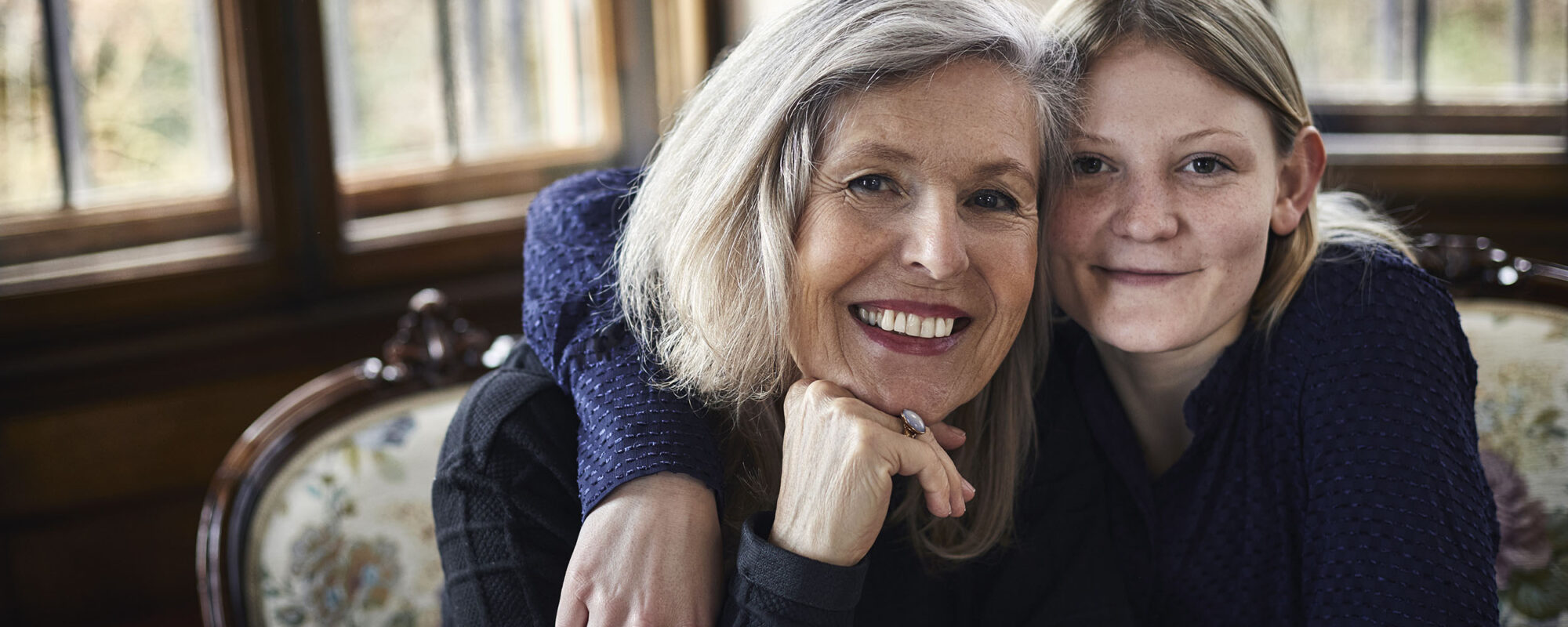 Portrait of smiling older and younger woman.