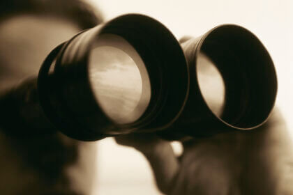 Man looking through binoculars