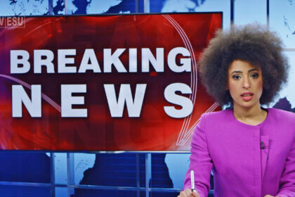 Female anchor presenting breaking news.