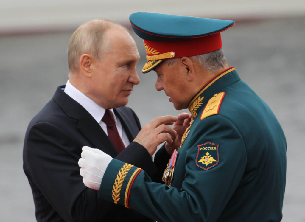 Russian president Vladimir Putin talks to defence minister Sergei Shoigu.