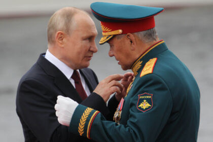 Russian president Vladimir Putin talks to defence minister Sergei Shoigu.