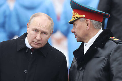 Russian President Vladimir Putin (L) listens to Defence Minister Sergei Shoigu (R) while taking part in the wreath laying ceremony at the Unknown Soldier Tomb, marking the Defender of the Fatherland's Day, on February 23, 2024, in Moscow, Russia.